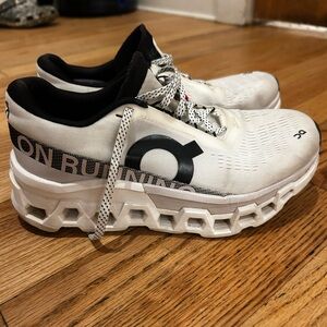 On Running White and Black Athletic Shoes